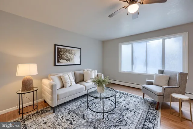 a living room with furniture and a large window