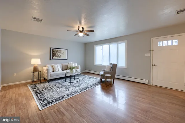 a living room with furniture rug and window