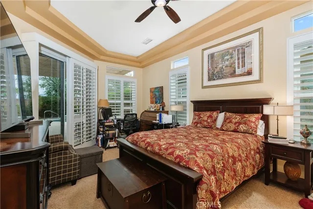 a bedroom with a bed and glass walk in closet