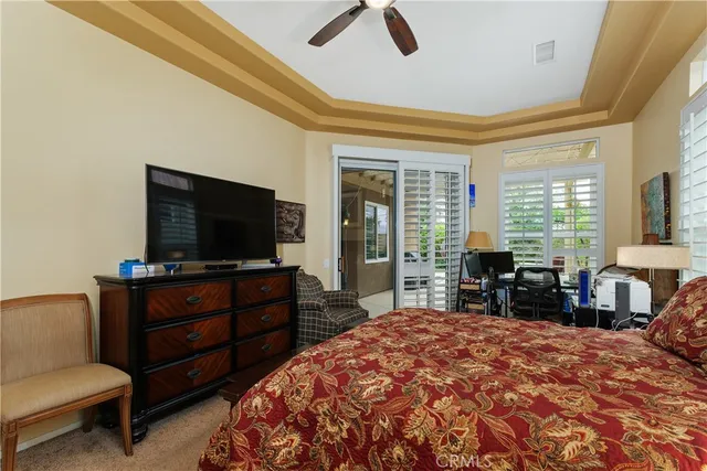 a bedroom with furniture and a flat screen tv