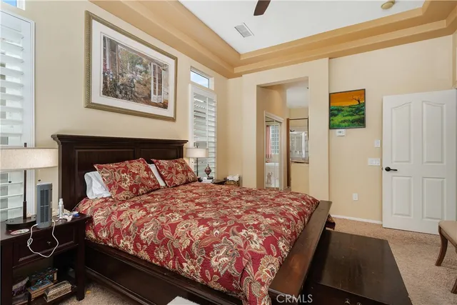 a large bed sitting in a bedroom next to a window