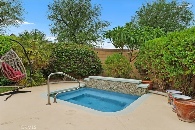 a view of a swimming pool with a patio and a yard