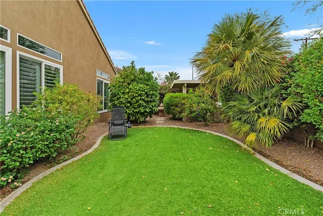 a view of yard with swimming pool and garden