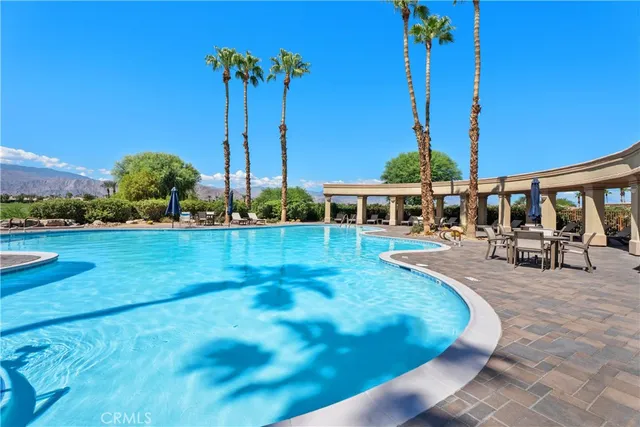a view of a swimming pool with a table and chairs