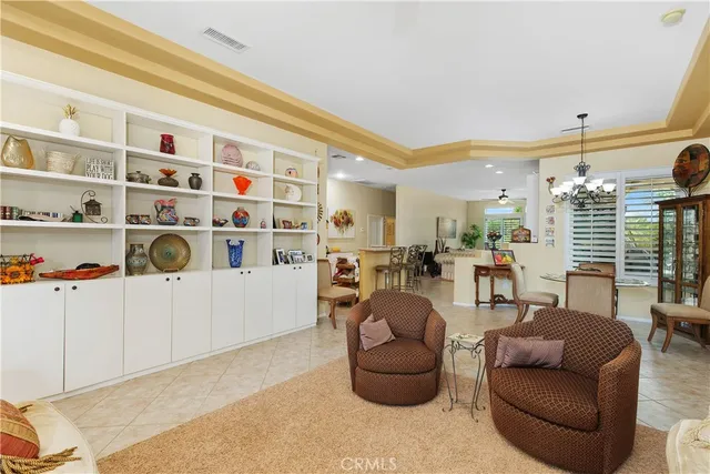 a living room with furniture and a book shelf
