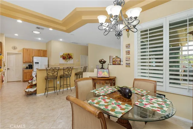 a view of a dining room with furniture and a chandelier