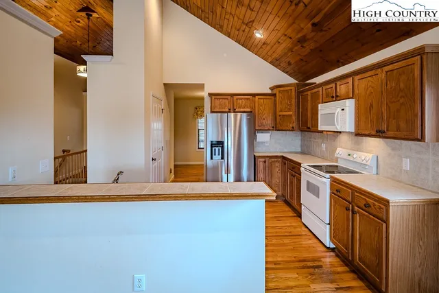 a kitchen with stainless steel appliances granite countertop a sink and cabinets