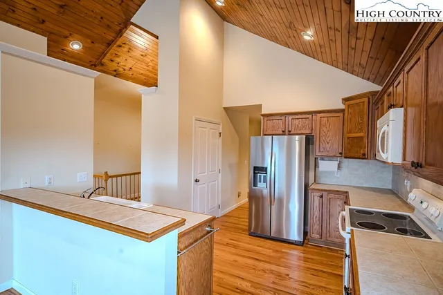 a kitchen with stainless steel appliances granite countertop a refrigerator and a stove