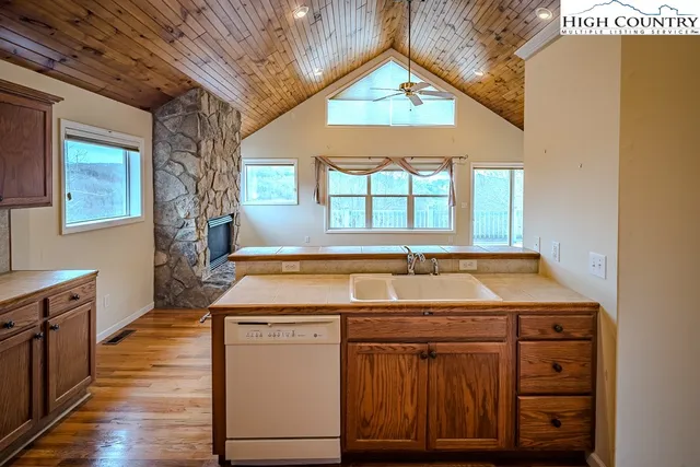 a kitchen with a stove sink and cabinets