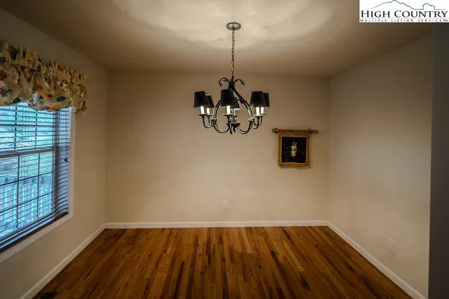 a view of a room with wooden floor and windows