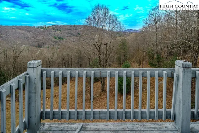 a view of a balcony with wooden fence