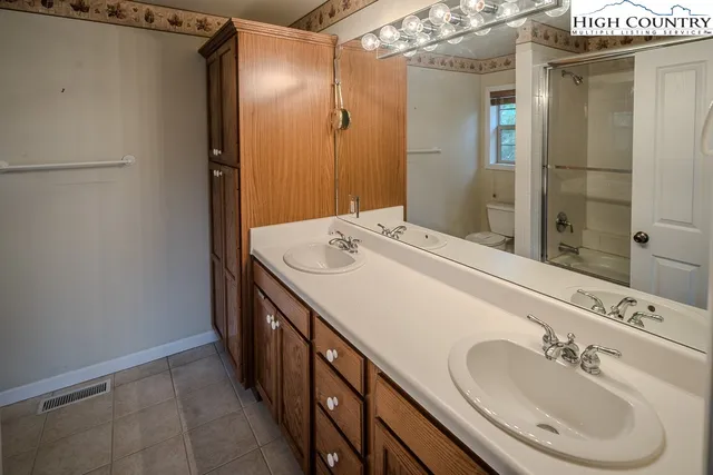 a bathroom with a double vanity sink and mirror