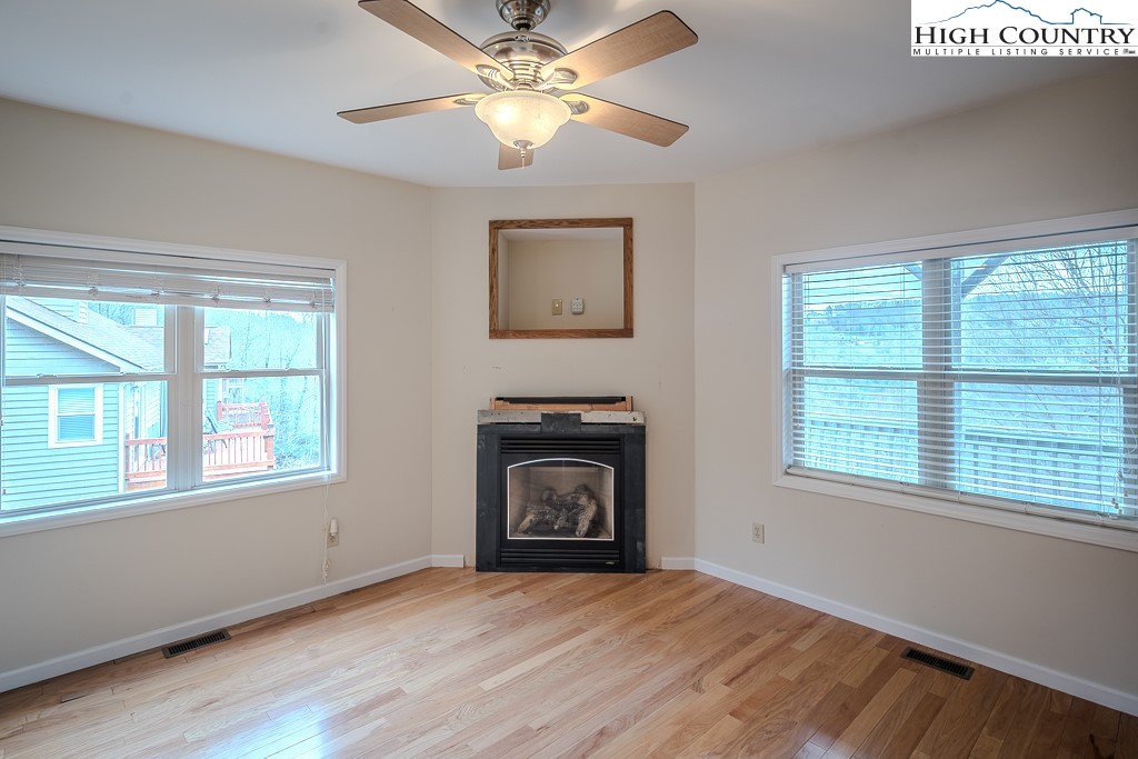1394 Grandview Drive Extension Boone, NC 28607 - Photo 34 of 44 a view of an empty room with chandelier fan and a fireplace