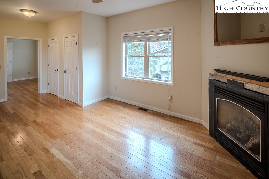1394 Grandview Drive Extension Boone, NC 28607 - Photo 37 of 44 a view of an empty room with wooden floor and a window