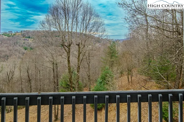 a aerial view of a house with a yard and balcony