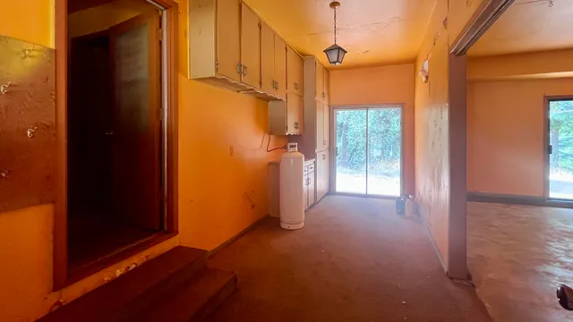 a kitchen with granite countertop a sink a stove and a dining table