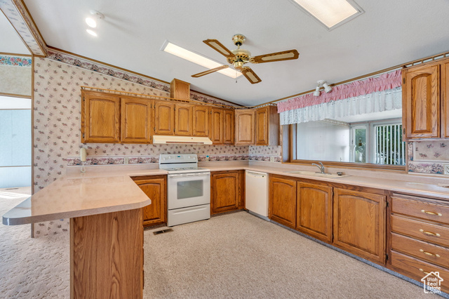 12958 South 300 East Draper, UT 84020 - Photo 33 of 38 Kitchen with lofted ceiling, a peninsula, white appliances, light countertops, and brown cabinetry