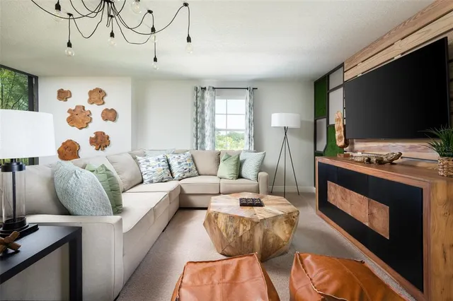 a living room with furniture and flat screen tv