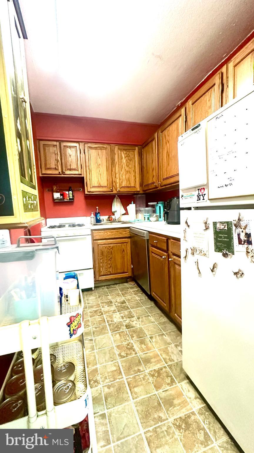 2101 Chestnut Street, Unit 317 Philadelphia, PA 19103 - Photo 28 of 39 a kitchen with a stove a sink and a refrigerator
