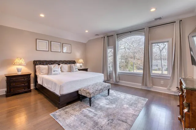 a bedroom with a large bed and a large window