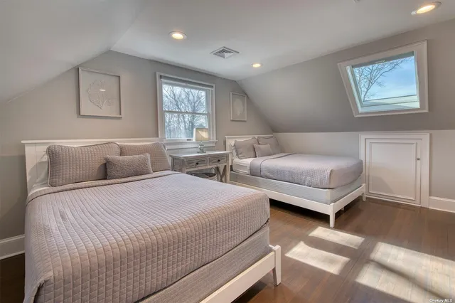 a bedroom with two beds and a window