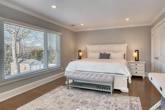 a bedroom with a bed and a large window