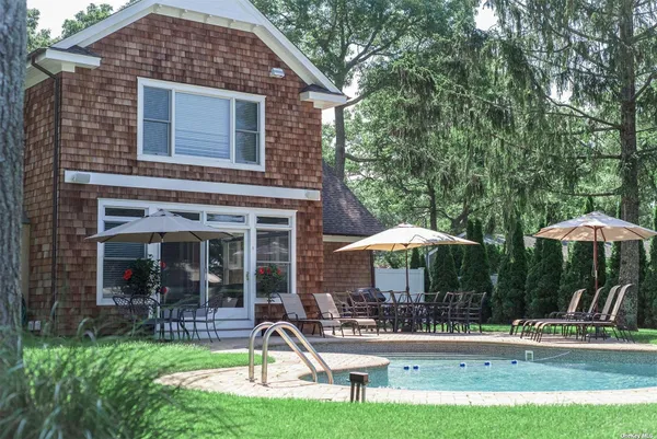a front view of a house with garden and porch