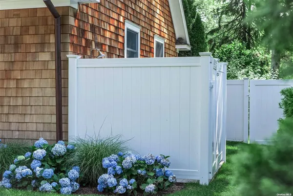 a house with a flower garden in front of it