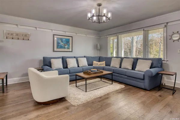 a living room with furniture and a chandelier