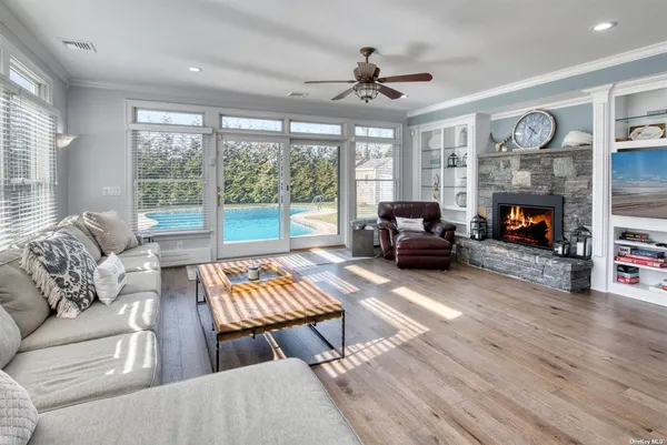 a living room with furniture fireplace and a large window