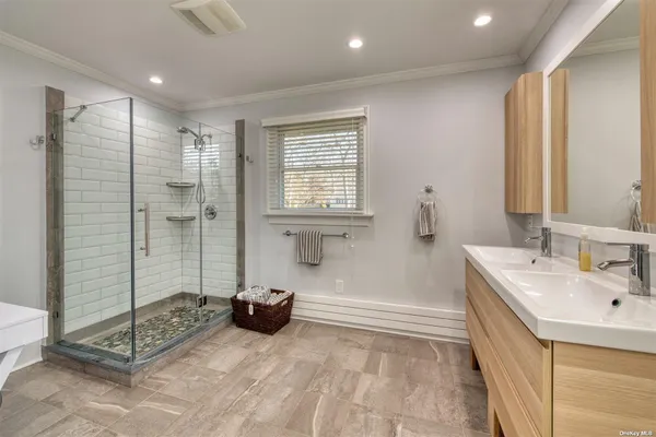 a bathroom with a tub sink and mirror