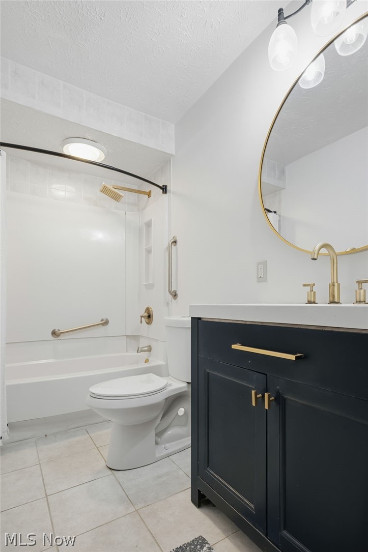 8160 Joyce Road Broadview Heights, OH 44147 - Photo 29 of 45 Bathroom featuring a dark blue vanity with gold hardware, a white countertop, and a round gold-framed mirror
