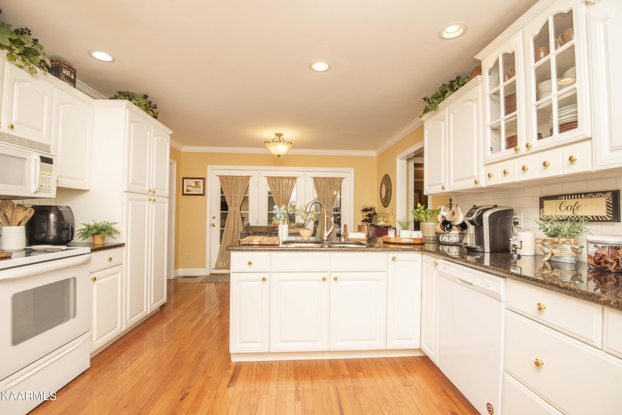 7412 Ridge Haven Court Corryton, TN 37721 - Photo 17 of 59 a kitchen with stainless steel appliances granite countertop a stove and white cabinets
