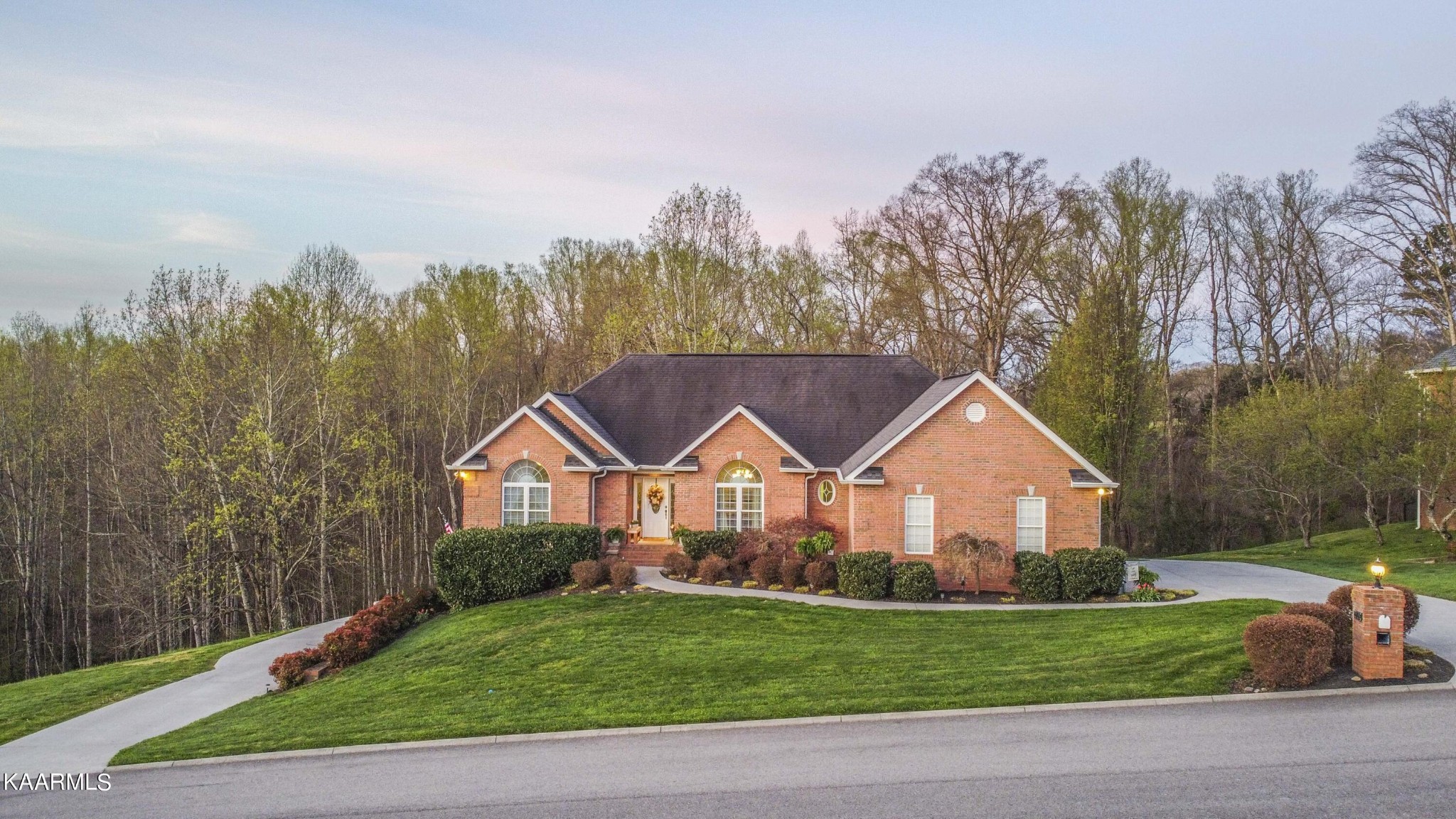 7412 Ridge Haven Court Corryton, TN 37721 - Photo 2 of 59 a view of a yard in front of a house with large trees