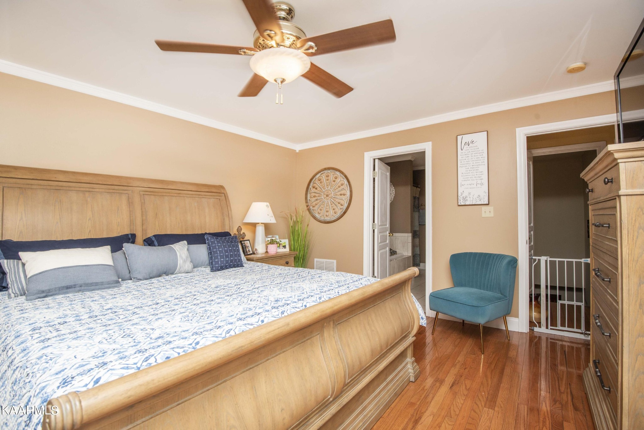 7412 Ridge Haven Court Corryton, TN 37721 - Photo 23 of 59 a bedroom with a bed and dresser with wooden floor