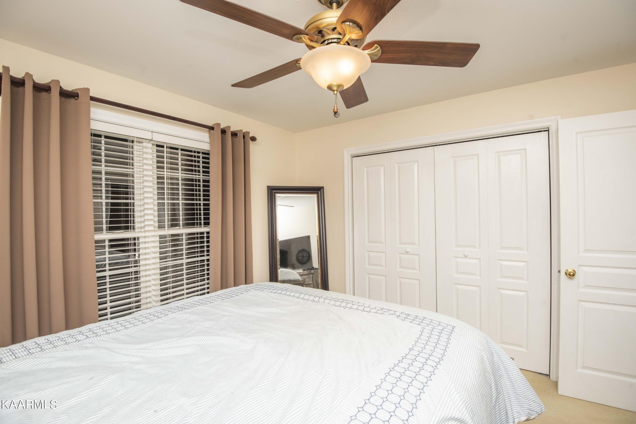 7412 Ridge Haven Court Corryton, TN 37721 - Photo 28 of 59 a bedroom with a large bed and a chandelier fan