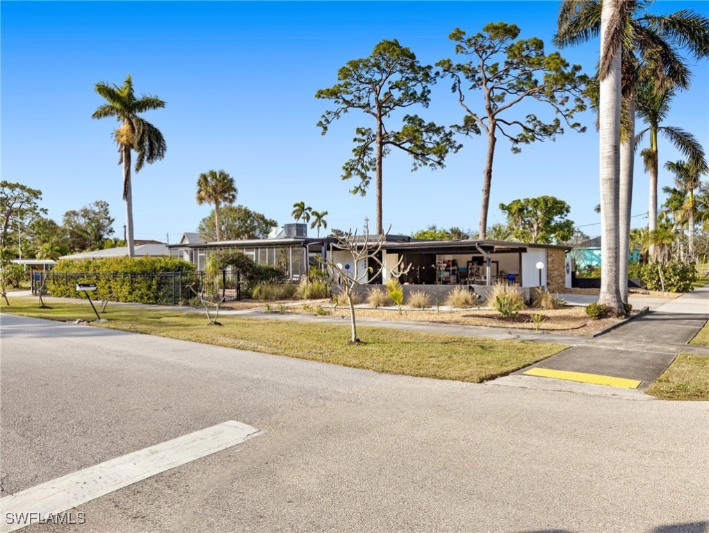 3666 Princeton Street Fort Myers, FL 33901 - Photo 2 of 31 a view of a swimming pool with a table and chairs