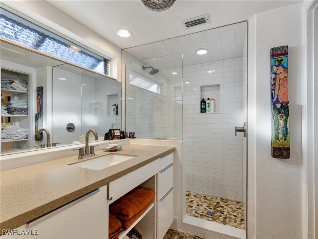 3666 Princeton Street Fort Myers, FL 33901 - Photo 21 of 31 a bathroom with a sink a mirror and shower