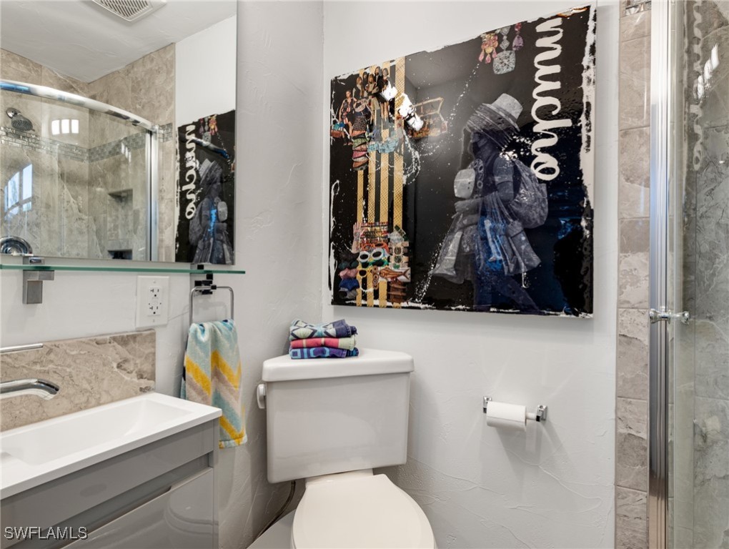 3666 Princeton Street Fort Myers, FL 33901 - Photo 26 of 31 a bathroom with a sink mirror vanity and toilet