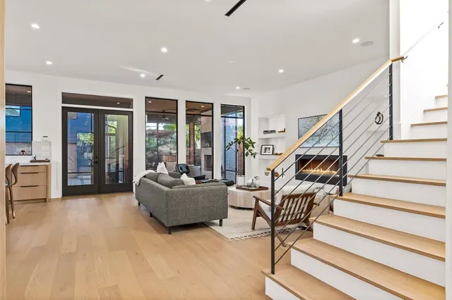 a living room with furniture and stairs