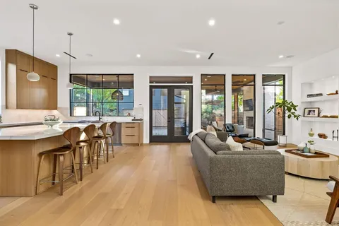 a living room with furniture and large windows