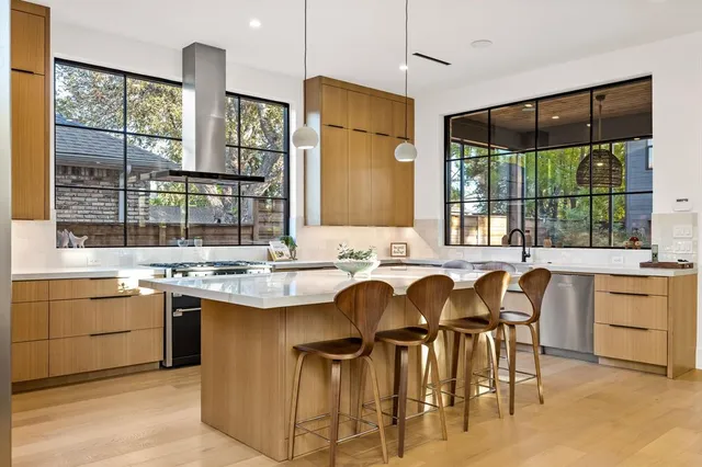 a kitchen with a table chairs sink and cabinets