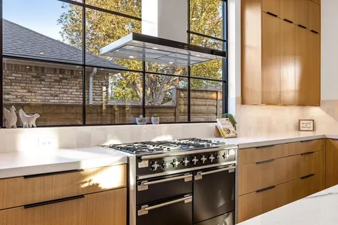 a kitchen with stainless steel appliances granite countertop a stove and a sink
