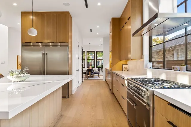 a large white kitchen with a large window