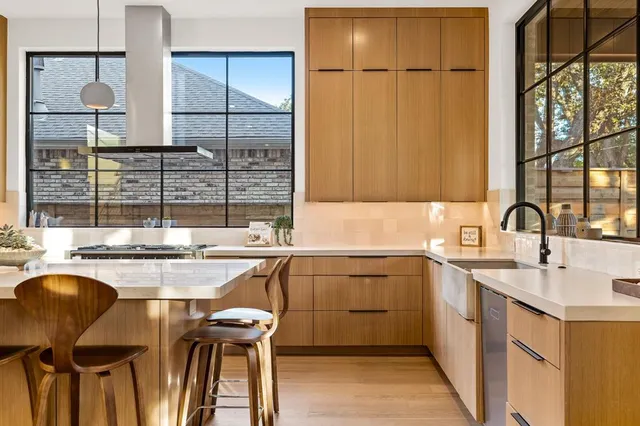 a kitchen with a sink and a stove top oven