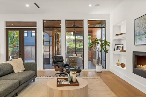 a living room with furniture large window and flat screen tv