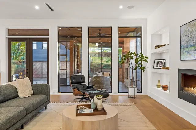 a living room with furniture large window and flat screen tv