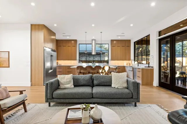 a living room with furniture and kitchen view