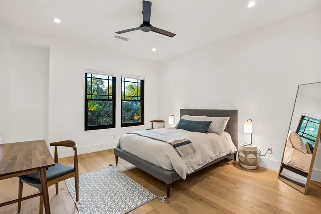 a bedroom with a bed a window and walk in closet