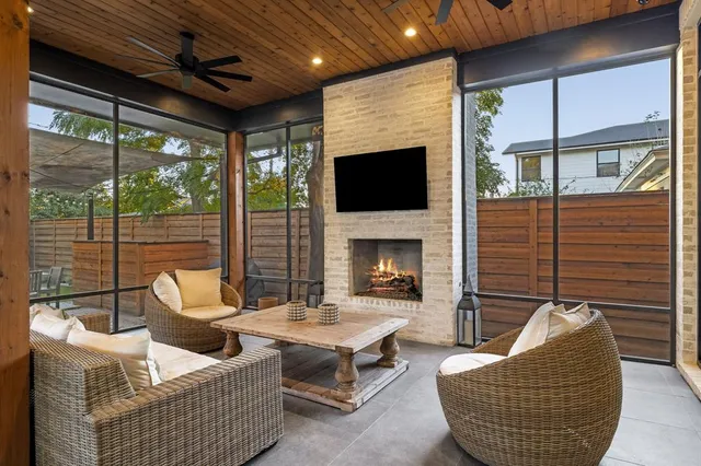 a living room with furniture a flat screen tv and a fireplace